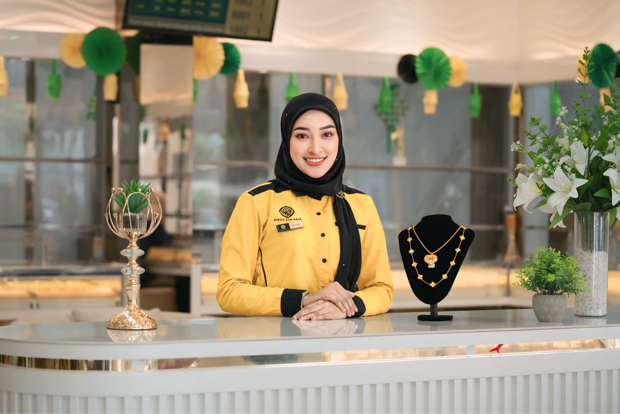 An advisor welcoming a customer at an Emas Zakaria branch